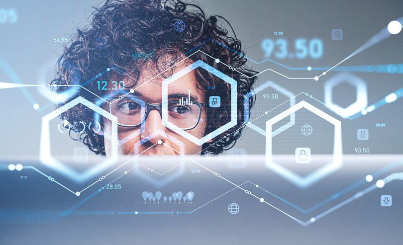 Businessman with device, pensive look and eyeglasses, blockchain hologram and numbers with rising lines, digital analytics.