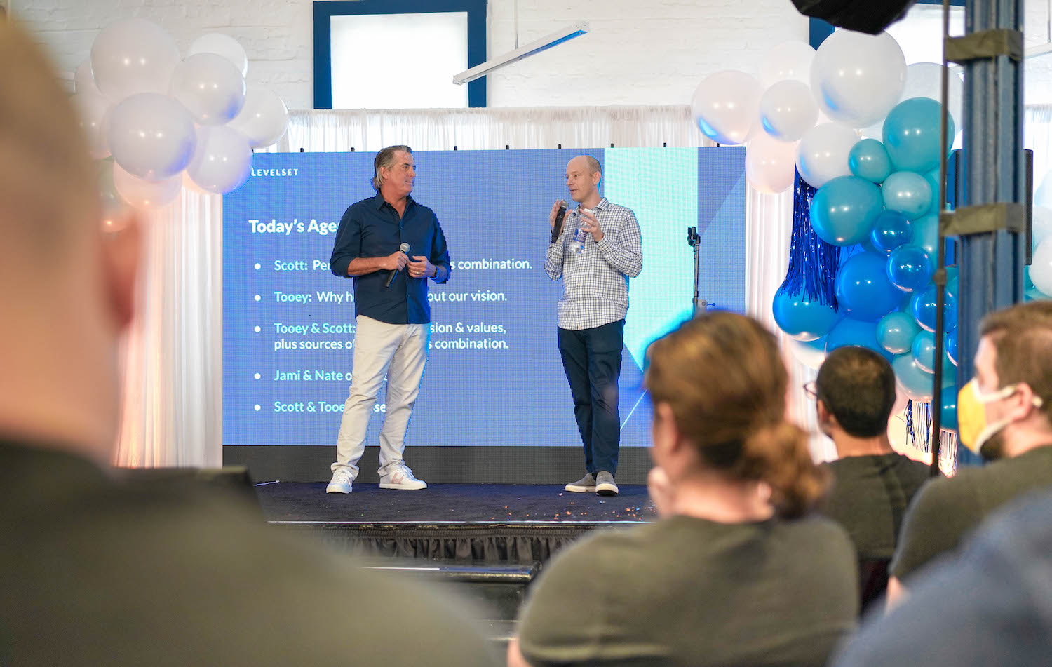 Procore founder and  CEO Tooey Courtemanche, left, joins Levelset CEO Scott Wolfe, Jr. in announcing the acquisition to Levelset employees at Levelset headquarters in New Orleans.