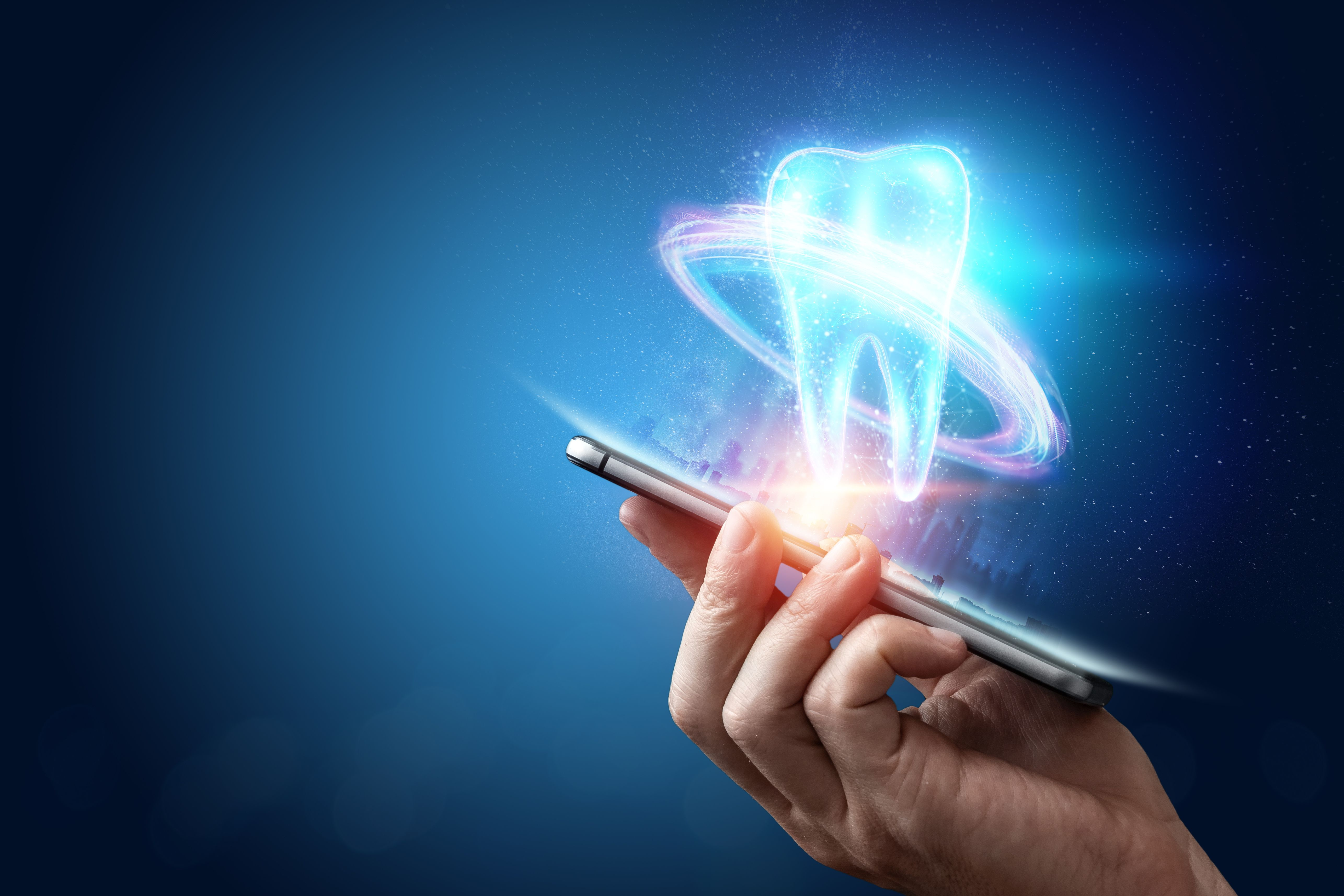 Smartphone sending out holographic image of a tooth.