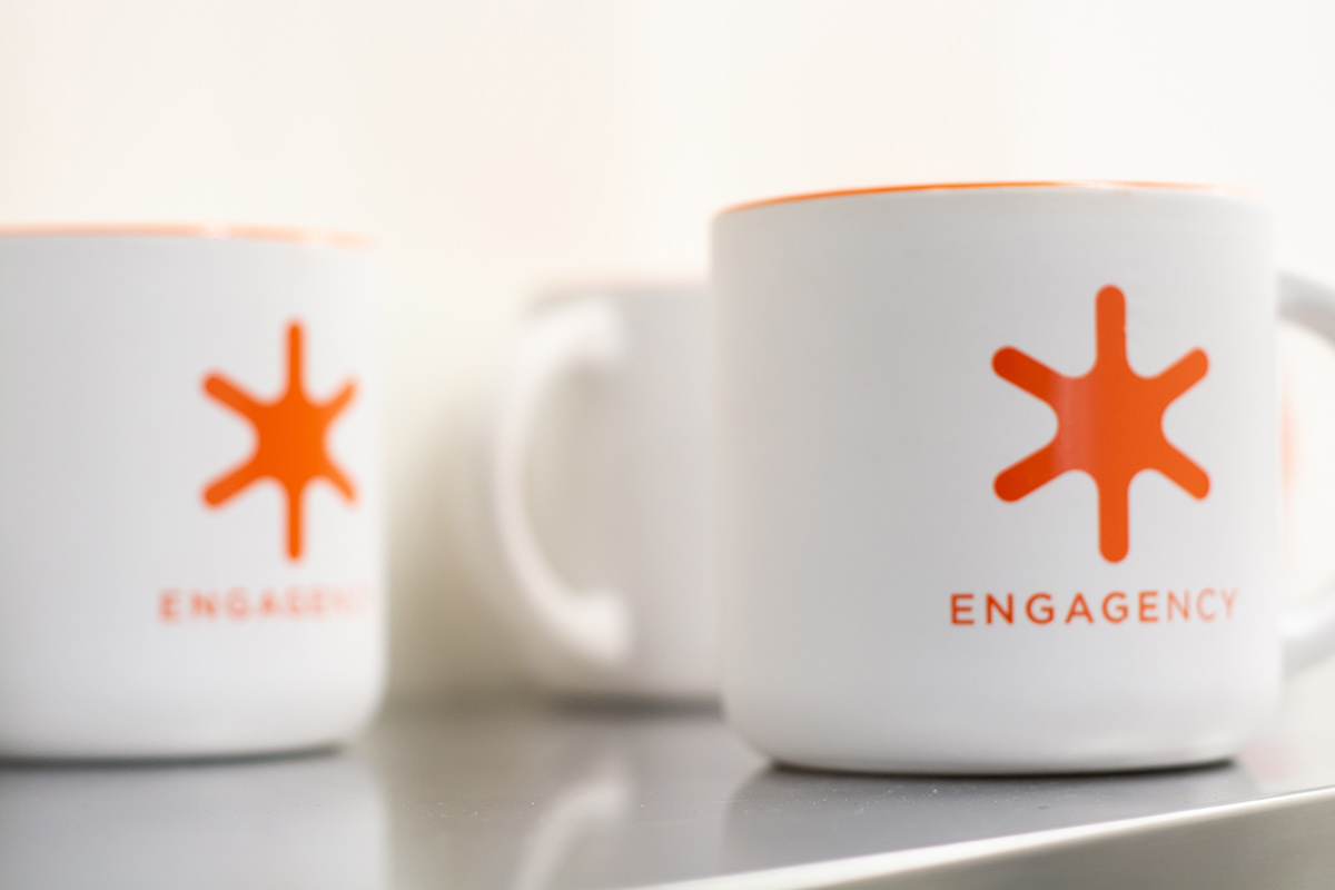 Mugs with the ENGAGENCY logo on them