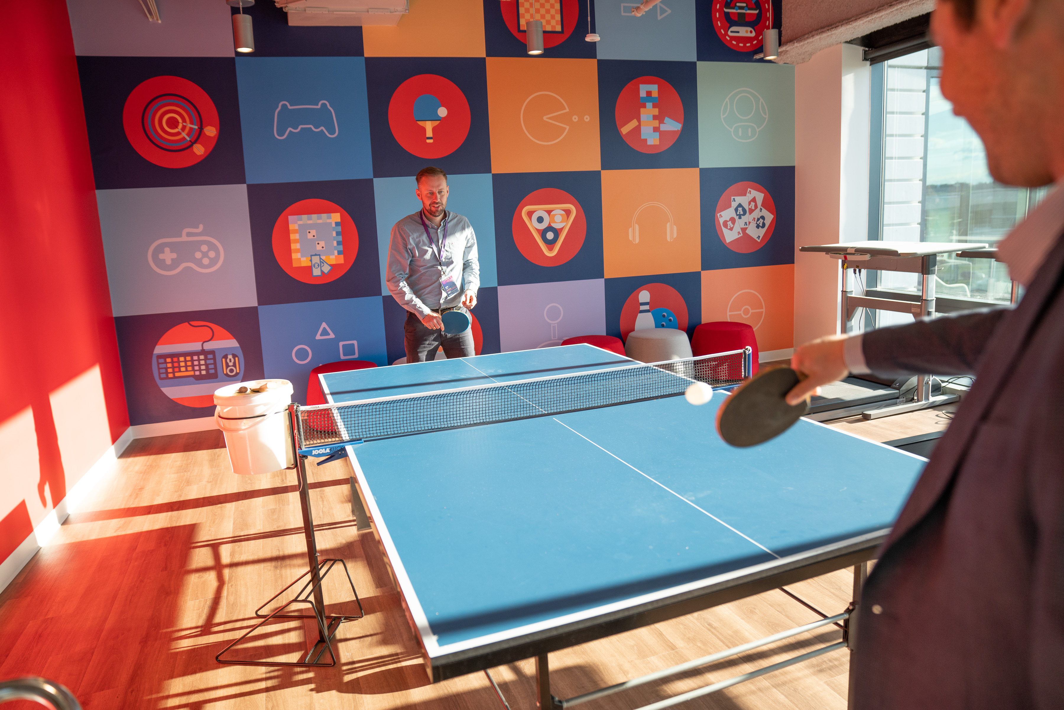 Imprivata team members playing ping pong in office