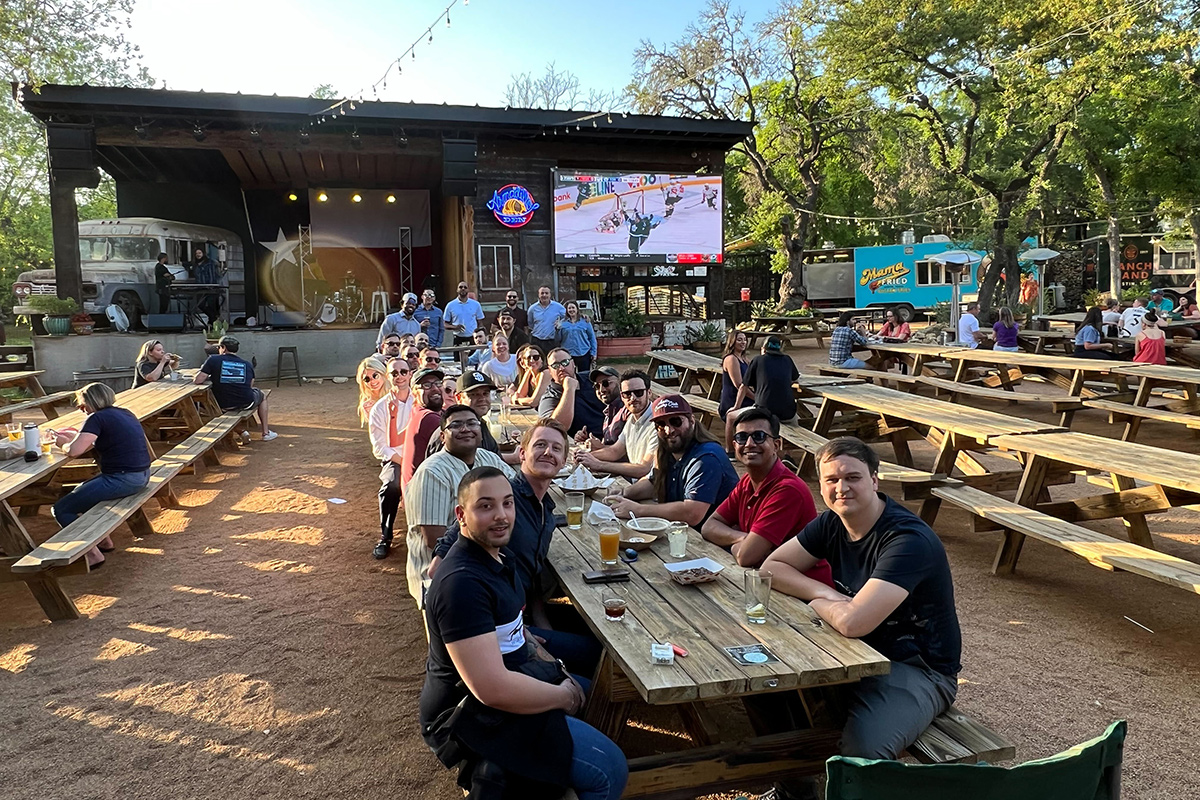 Invicti team members at an outdoor restaurant together