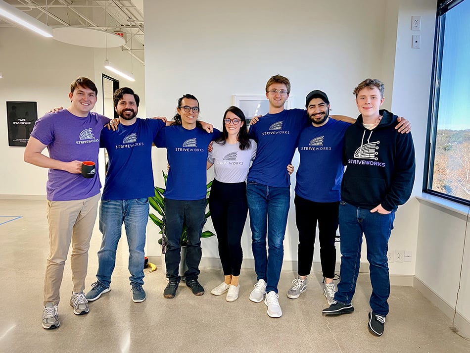Striveworks team members wearing t-shirts with the company logo 