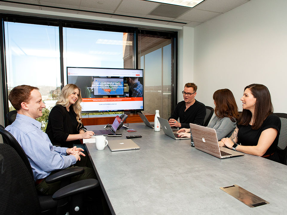 AlertMedia employees meet in a conference room