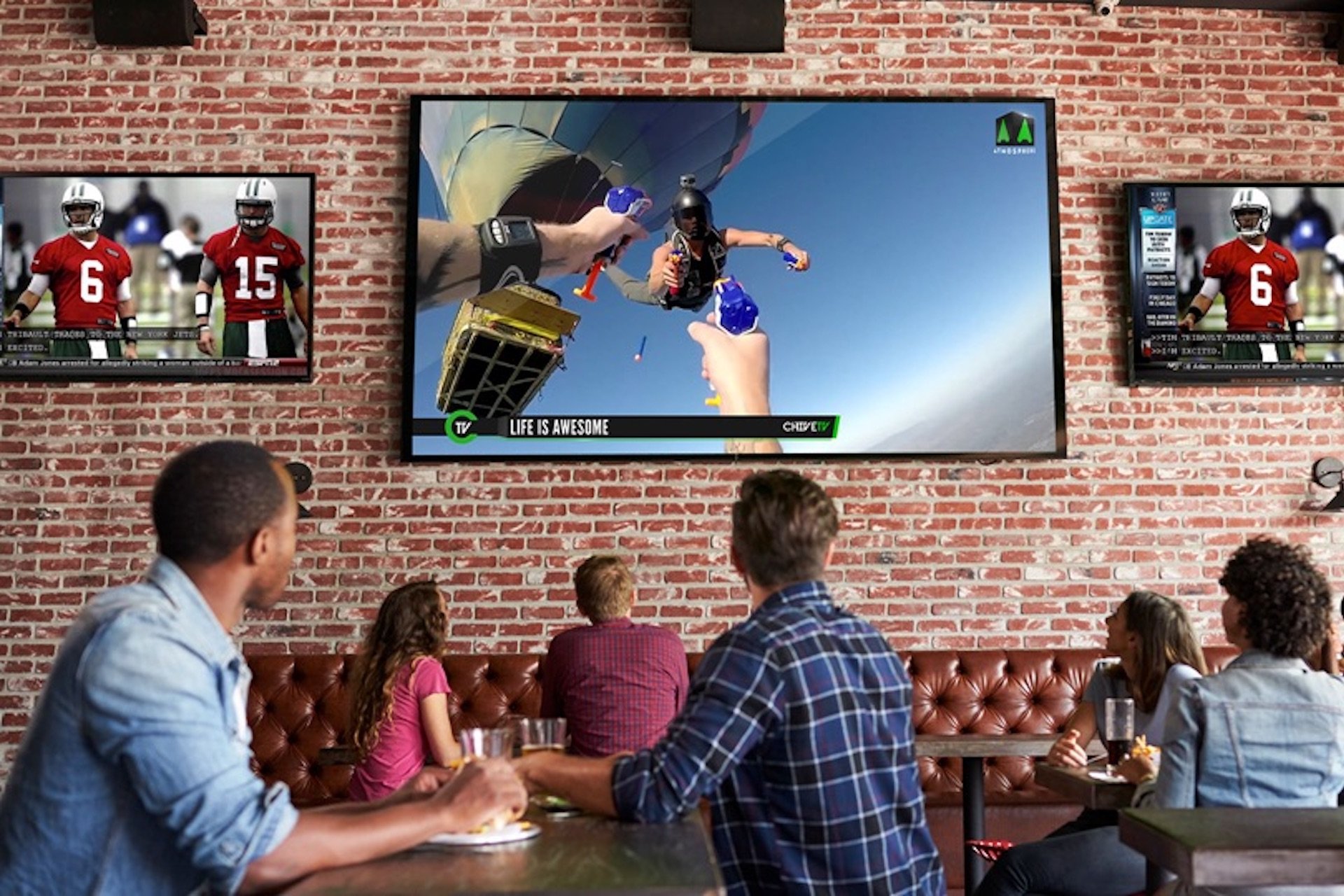 People watching a virtual game at a bar 