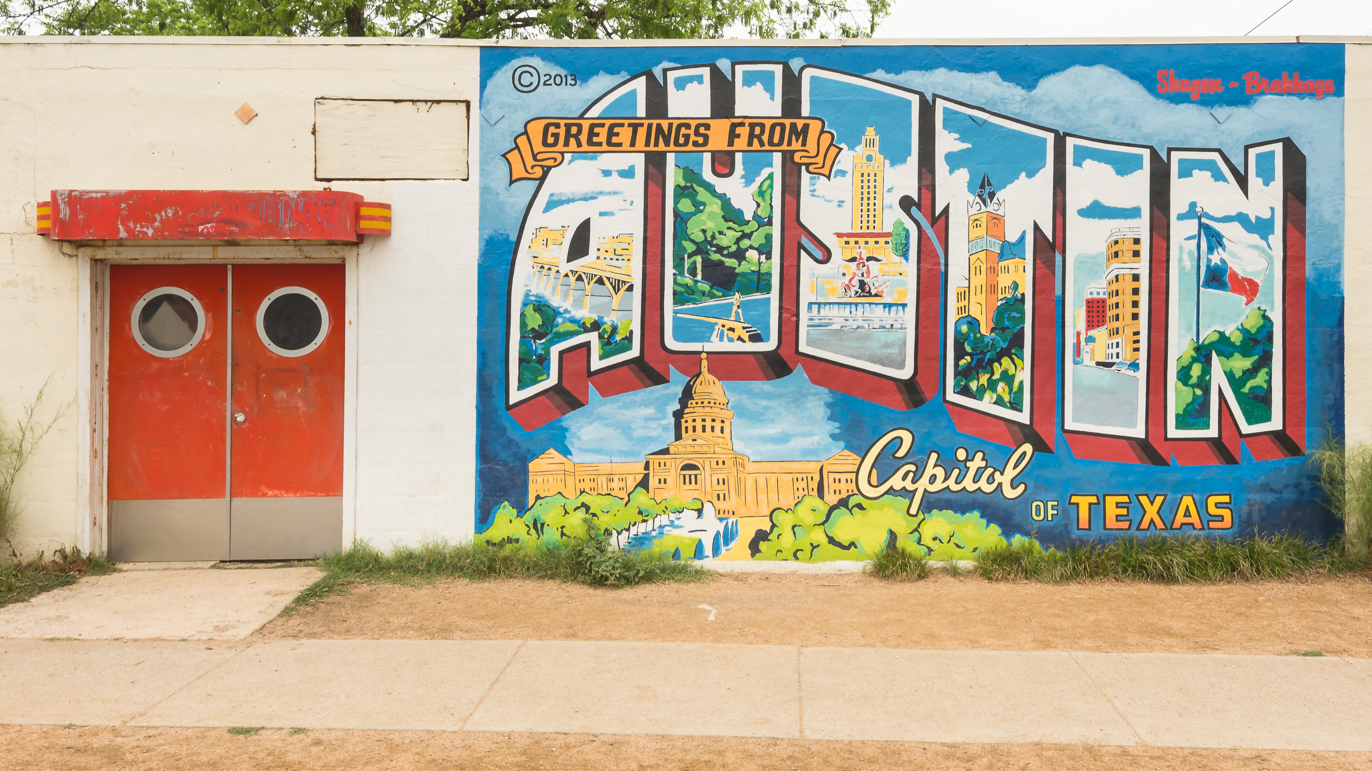 Inspired by a 1940s postcard, the vibrant mural depicts Austin landmarks like the Congress Avenue Bridge, The University of Texas Tower, and Barton Springs.