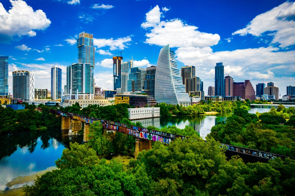 Austin skyline surrounded by a  river and forestry.