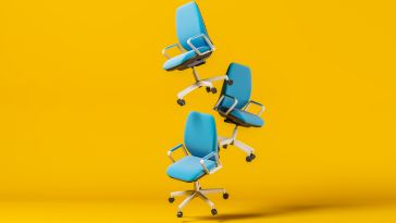 hree blue office chairs float in front of a yellow background. 