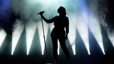 silhouette of a singer singing into a microphone