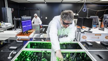TAU Systems CEO Bjorn Manuel Hegelich aligns laser beams at the University of Texas at Austin.