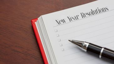 stock image of notebook with new year resolutions written on a page