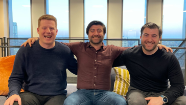 Beamery’s founders founding team pose for a photo while seated together.