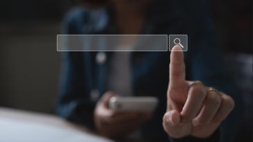 photo of person pointing a finger at a search bar
