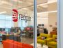 logo of redgate on glass door with view of office