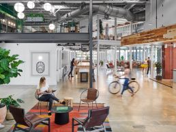 Inside of Favor's Eastside tech hub office space, with people moving about
